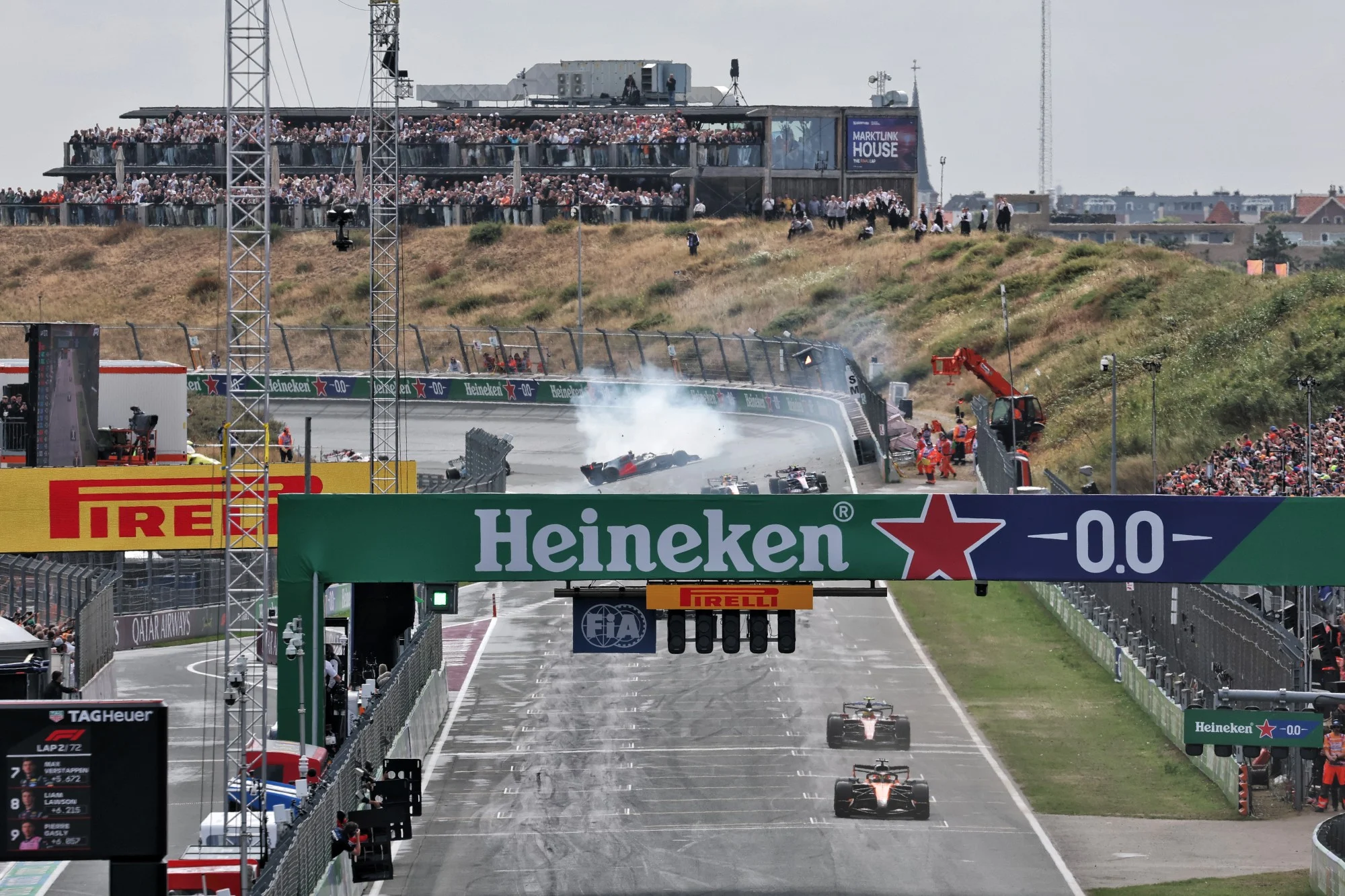 Lando Norris (GBR) McLaren F1 Team MCL40 leads as Gabriel Bortoleto (BRA) Audi F1 Team R26 spins in the background.
